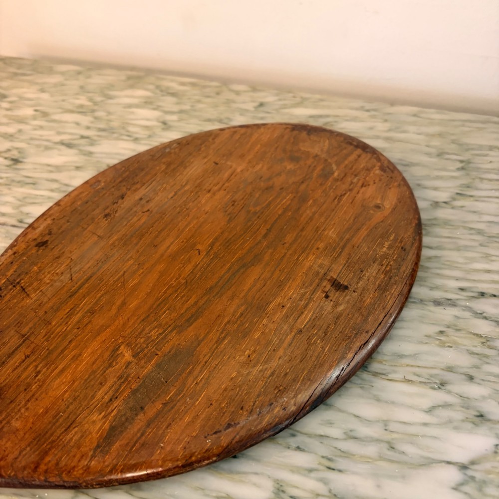An oval antique rosewood hand mirror featuring mother-of-pearl inlay on the contoured handle and a bevelled glass plate. View II