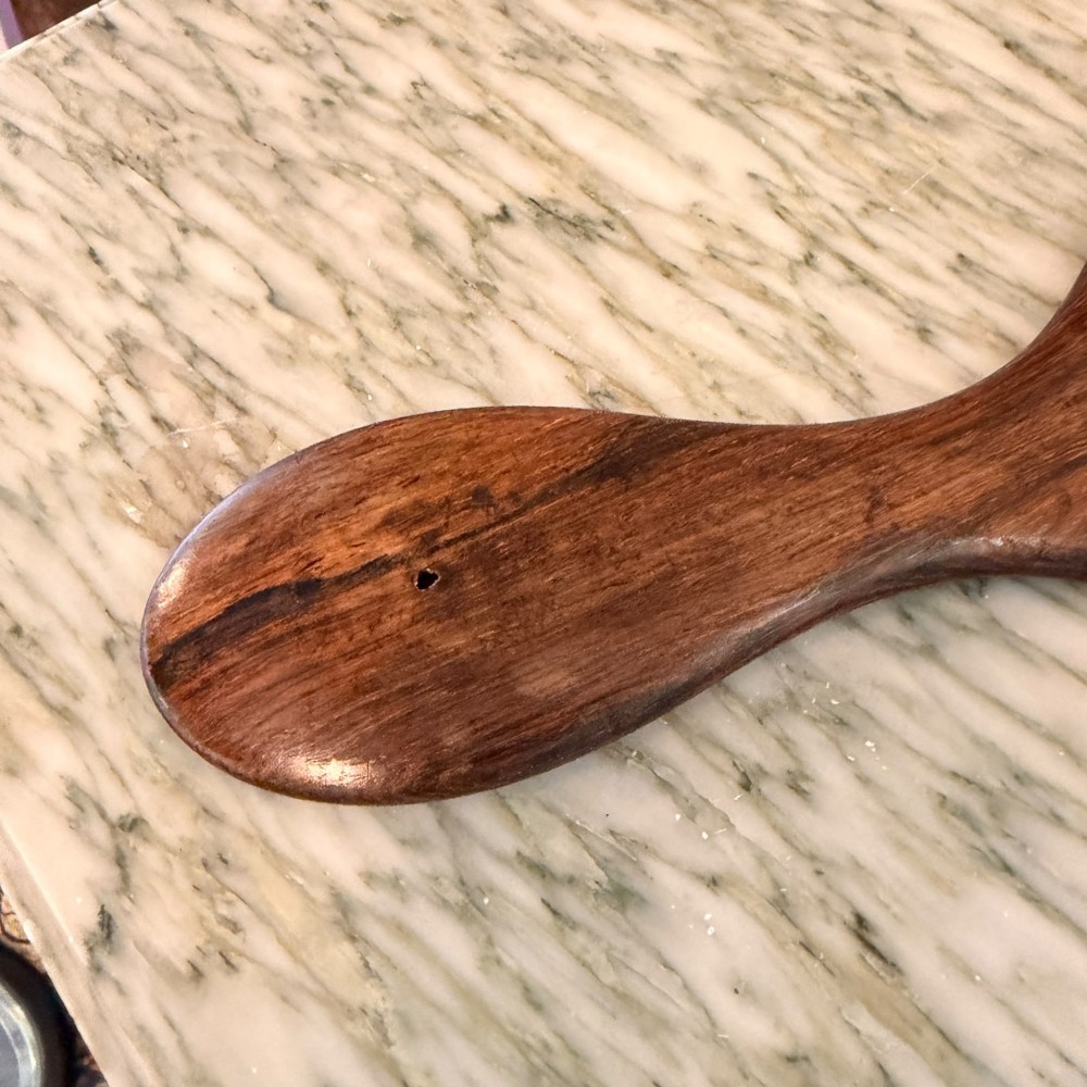 An oval antique rosewood hand mirror featuring mother-of-pearl inlay on the contoured handle and a bevelled glass plate. View V