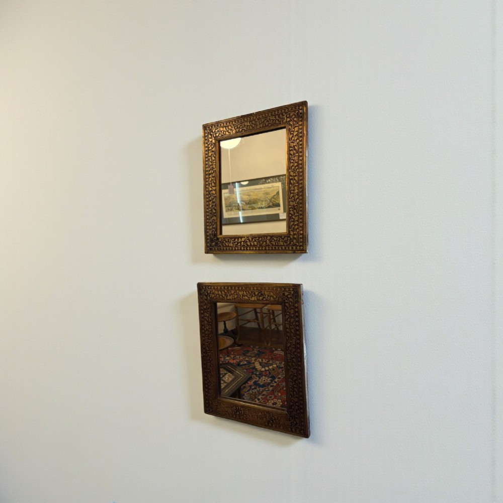A square wooden mirror featuring intricate brass floral wire inlay along its wide rectangular border. View III