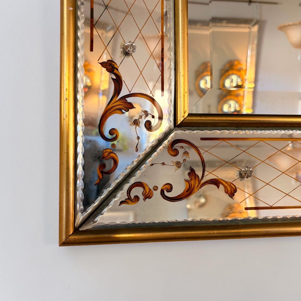 A rectangular Venetian style mirror featuring a central bevelled mirror plate surrounded by mirrored borders with gold scrollwork and diamond lattice etching. View II