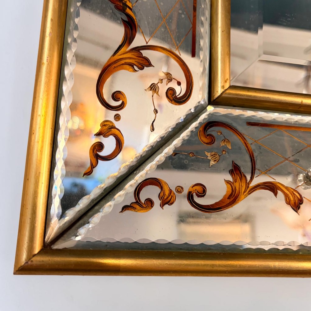 A rectangular Venetian style mirror featuring a central bevelled mirror plate surrounded by mirrored borders with gold scrollwork and diamond lattice etching. View III