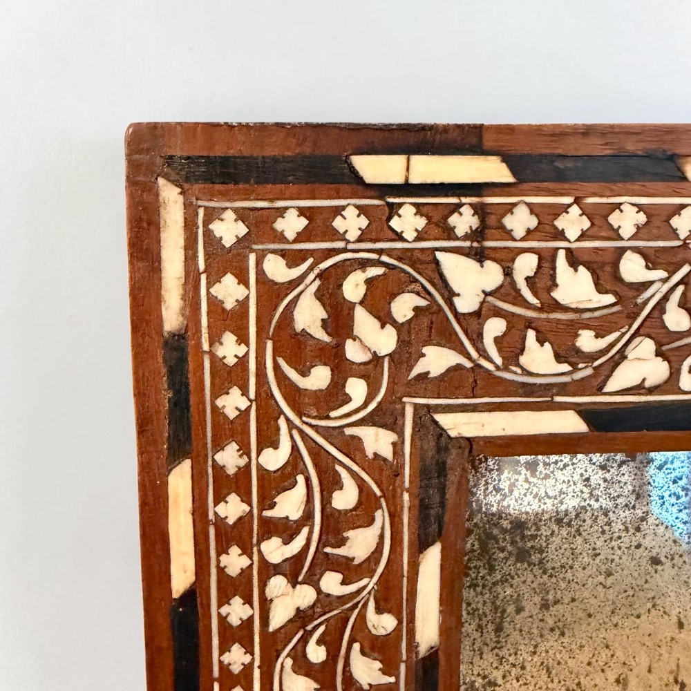 A rectangular late 19th-century Anglo-Indian wall mirror with floral bone inlay patterns surrounding a reflective glass plate. View II