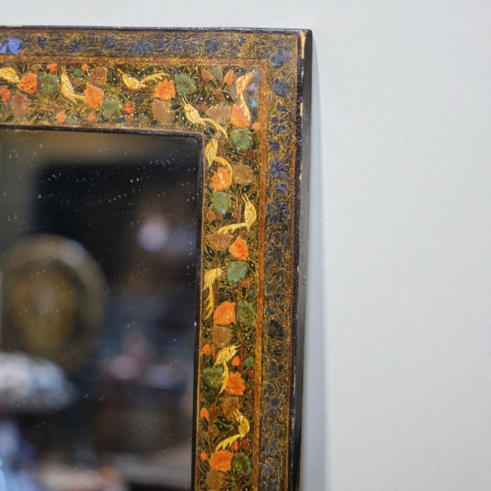 A rectangular wall mirror featuring a hand-painted lacquered frame decorated with intricate polychrome floral motifs in orange, green, and gold. View II