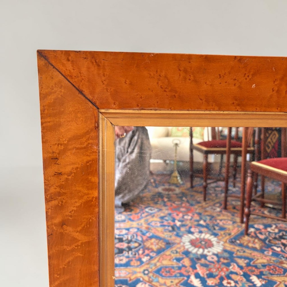 A rectangular William IV wall mirror featuring a wide birds eye maple veneer frame with a narrow gilded inner border. View II