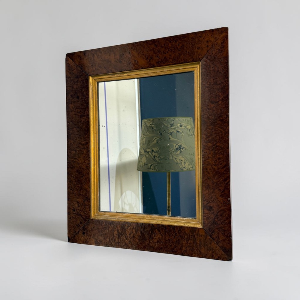 A 19th-century rectangular wall mirror featuring a wide burr walnut veneer frame with a gilded inner slip moulding.