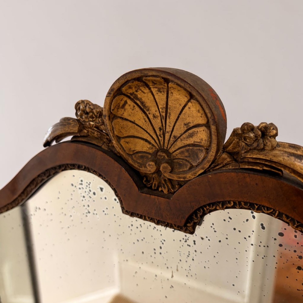 An Edwardian mahogany tri-fold dressing mirror featuring an arched central frame with a carved shell cresting and adjustable side panels. View III