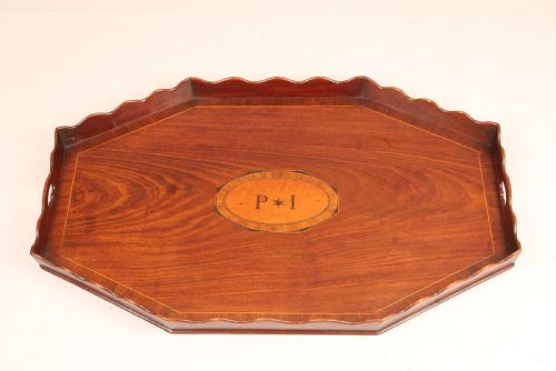 AN OCTAGONAL MAHOGANY TRAY WITH A WAVY GALLERY AND CARRYING HANDLES
