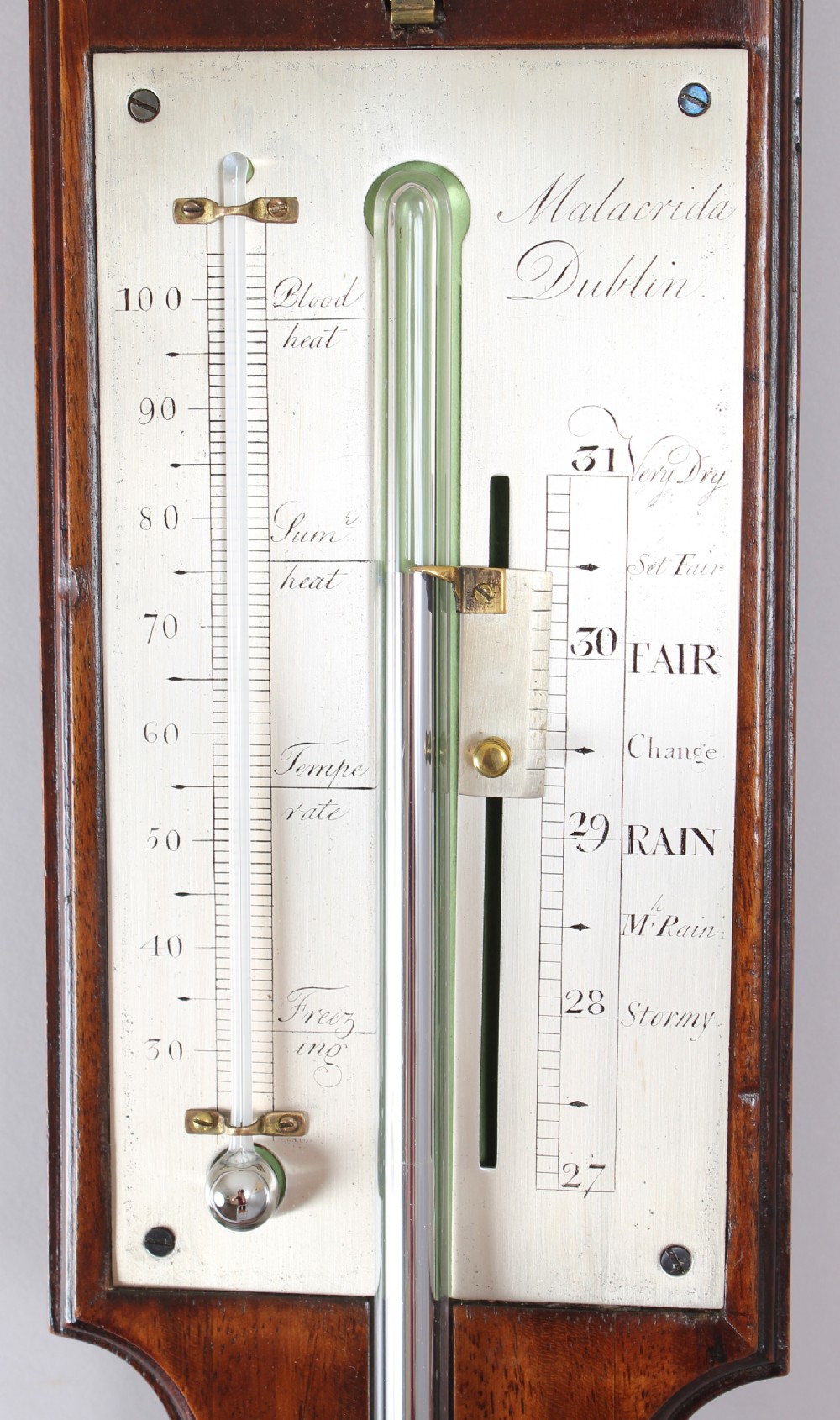An early nineteenth-century mahogany stick barometer featuring a pedimented top, brass finial, silvered register plates, and a rounded cistern cover at the base. View VI