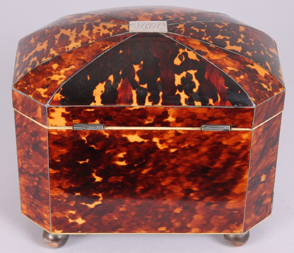 A Regency period bow-fronted tea caddy made from amber and brown tortoiseshell with a silver lid plate, escutcheon, and key. View III