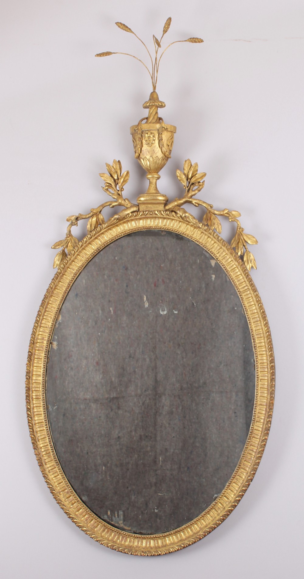 George III period carved and gilt wood wall mirror in the neo-classical style