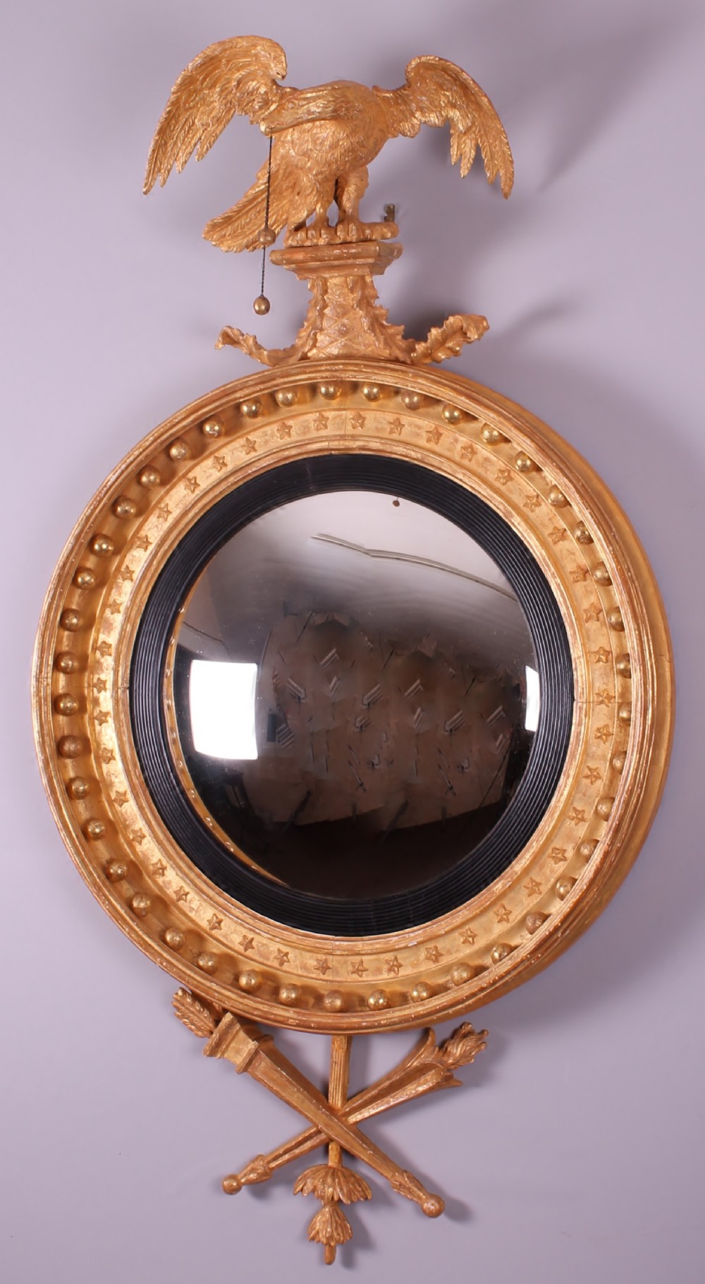 Regency period carved and gilded convex mirror