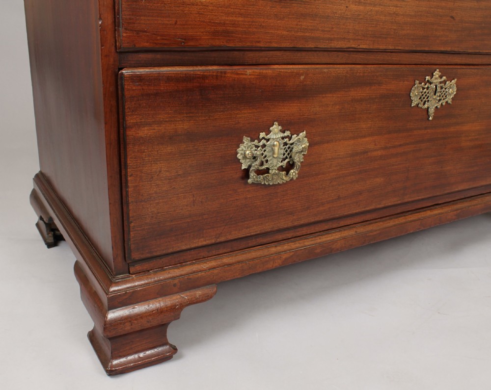A George II mahogany chest on chest featuring reeded canted corners, pierced brass handles, and bracket feet. View II