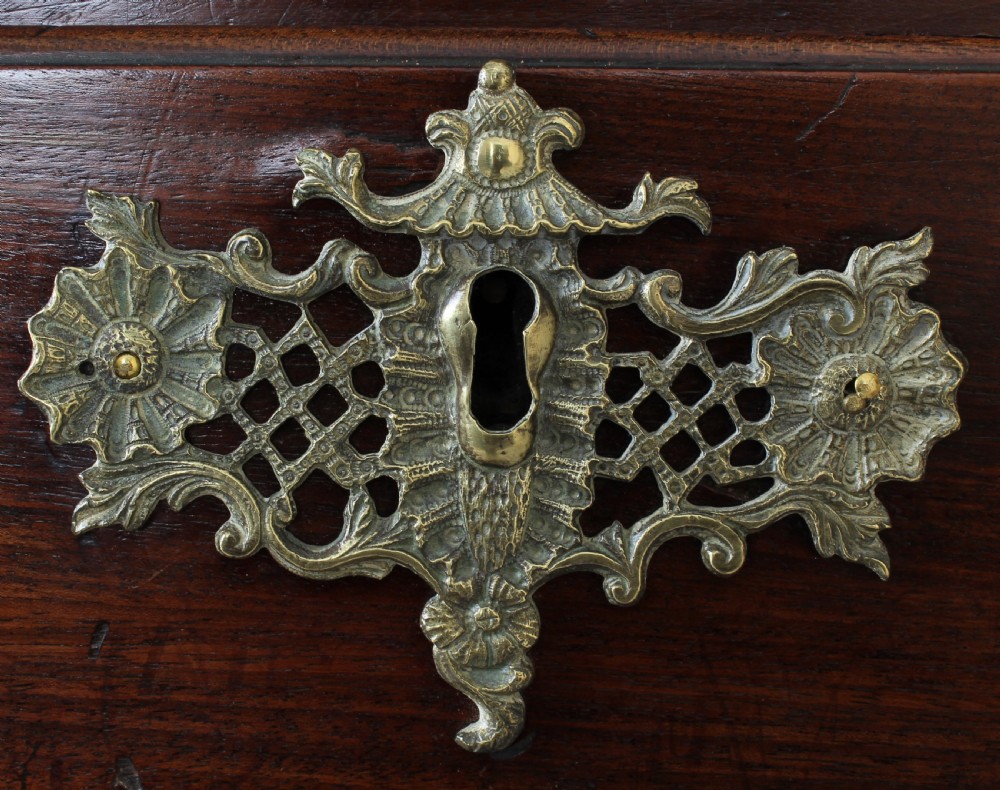 A George II mahogany chest on chest featuring reeded canted corners, pierced brass handles, and bracket feet. View III