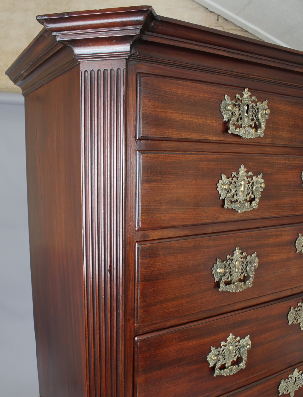 A George II mahogany chest on chest featuring reeded canted corners, pierced brass handles, and bracket feet. View IV