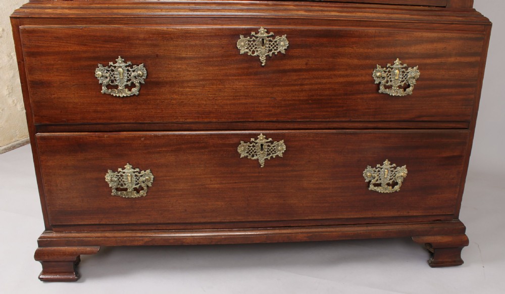 A George II mahogany chest on chest featuring reeded canted corners, pierced brass handles, and bracket feet. View V