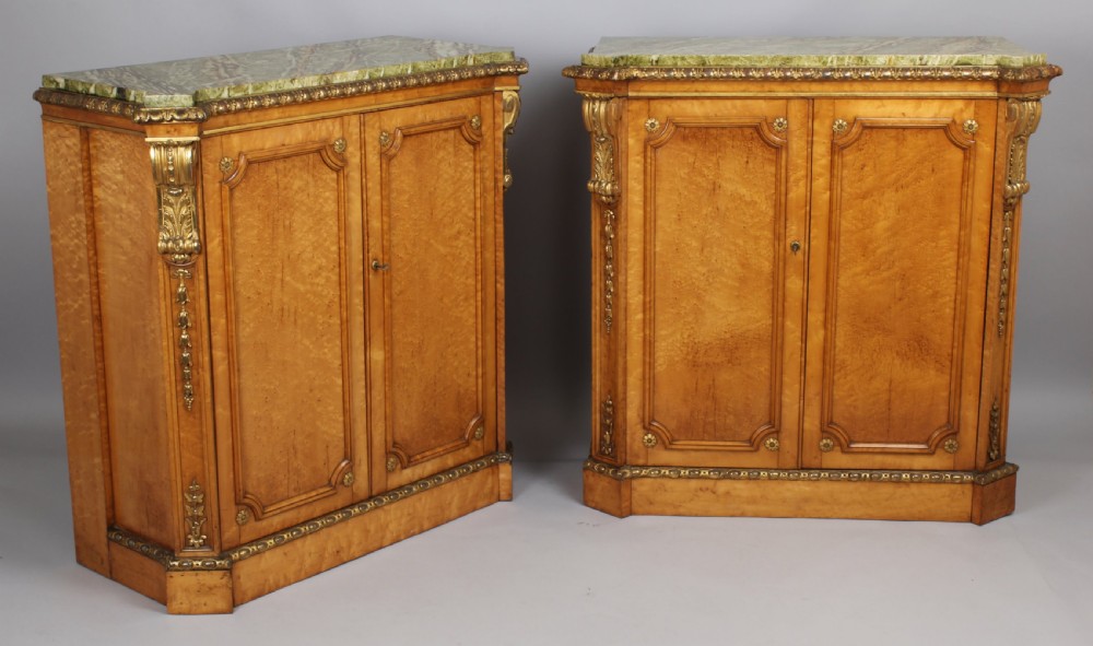 Fine pair of mid-nineteenth century birds'-eye maple and parcel-gilt side-cabinets