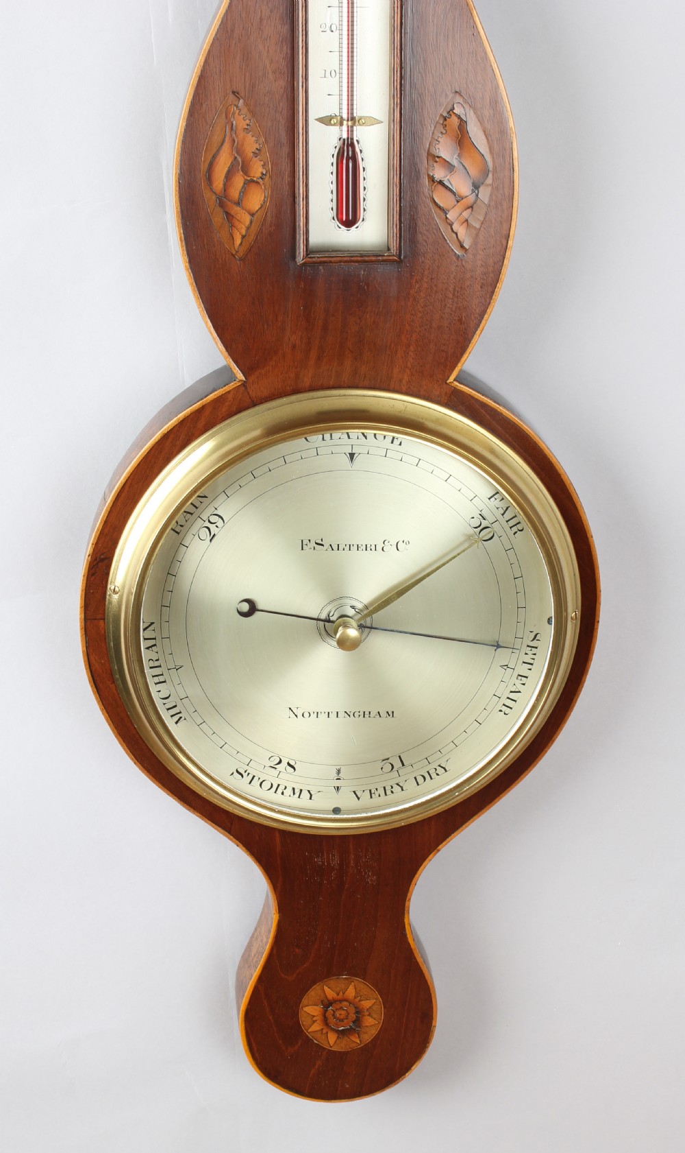 An early nineteenth-century mahogany wheel barometer featuring shell marquetry inlays, a broken arch pediment with brass finial, an integrated thermometer, and a silvered circular dial signed by F. Salteri and Company of Nottingham. View III