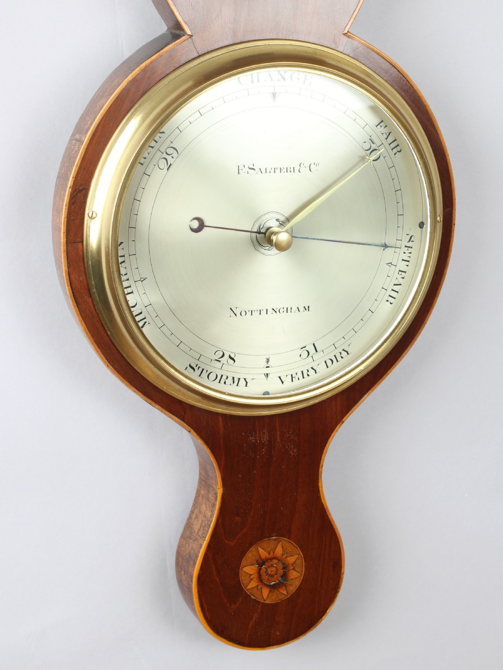An early nineteenth-century mahogany wheel barometer featuring shell marquetry inlays, a broken arch pediment with brass finial, an integrated thermometer, and a silvered circular dial signed by F. Salteri and Company of Nottingham. View IV