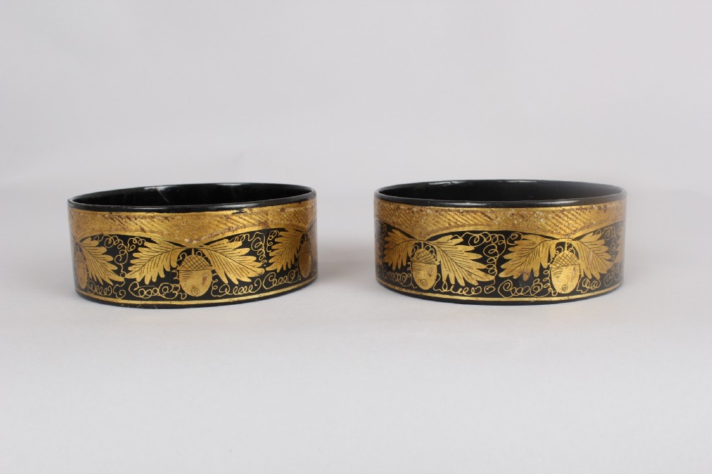 Pair of Regency black and gilt papier-mache coasters