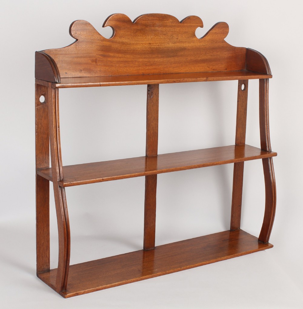 Set of small George IV period pale mahogany hanging shelves
