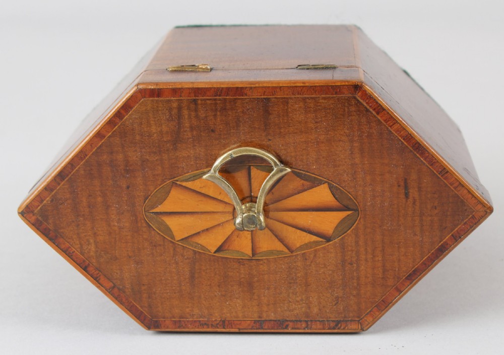 A George III hexagonal harewood tea caddy featuring oval fan marquetry motifs on its sides and top lid with a brass loop handle. View IV