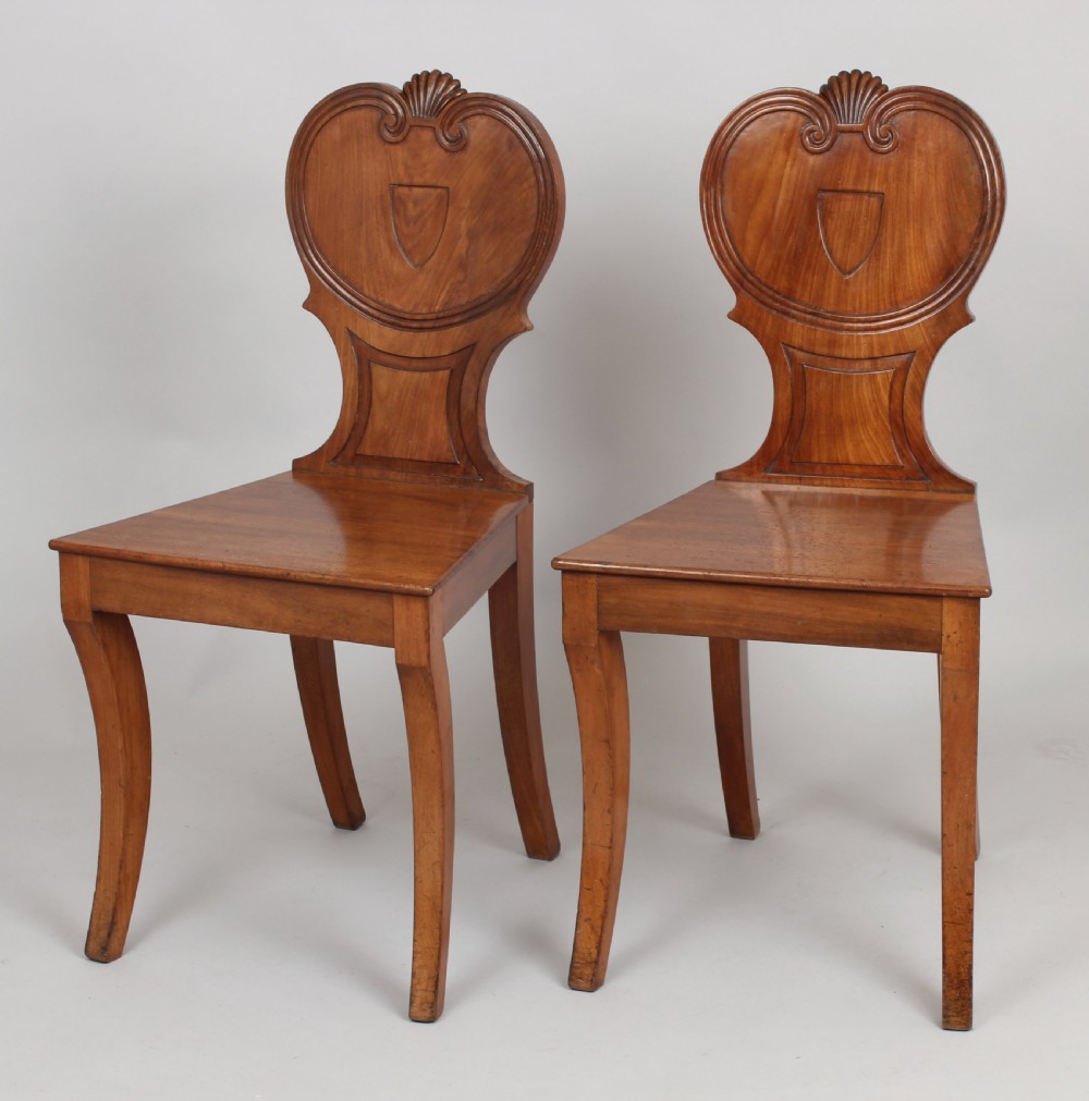 Pair of Regency period pale mahogany hall-chairs