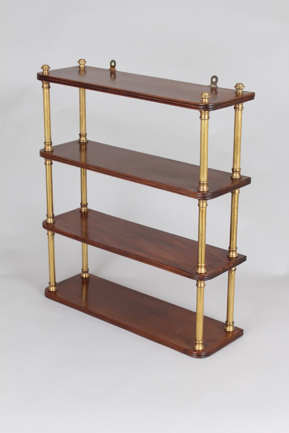 Mahogany and brass wall-shelf of Regency characters