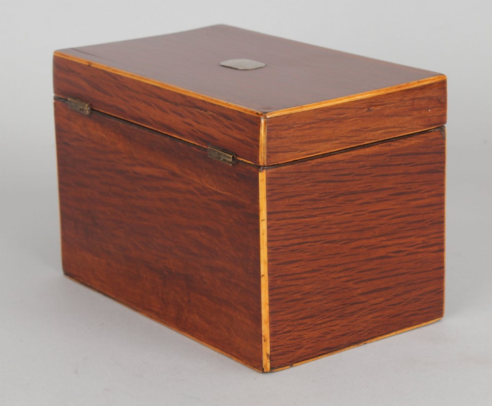 A rectangular George III partridge-wood tea caddy featuring dark dappled grain, boxwood stringing, a silver top plaque, and a diamond bone escutcheon. View IV