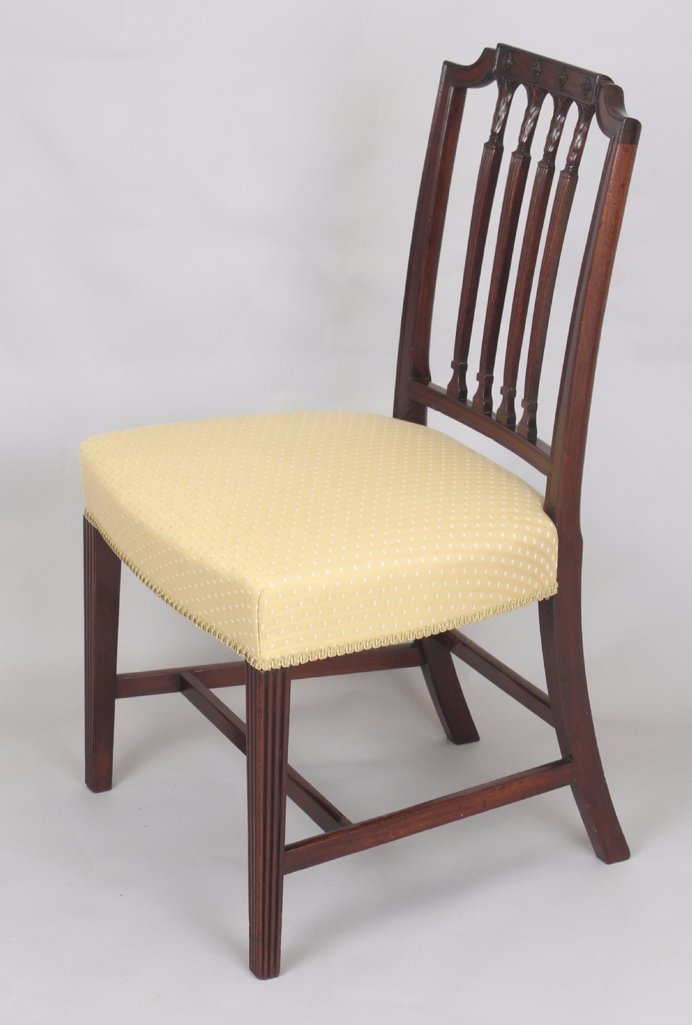 A set of six fine George III period mahogany dining-chairs in the Hepplewhite style View II