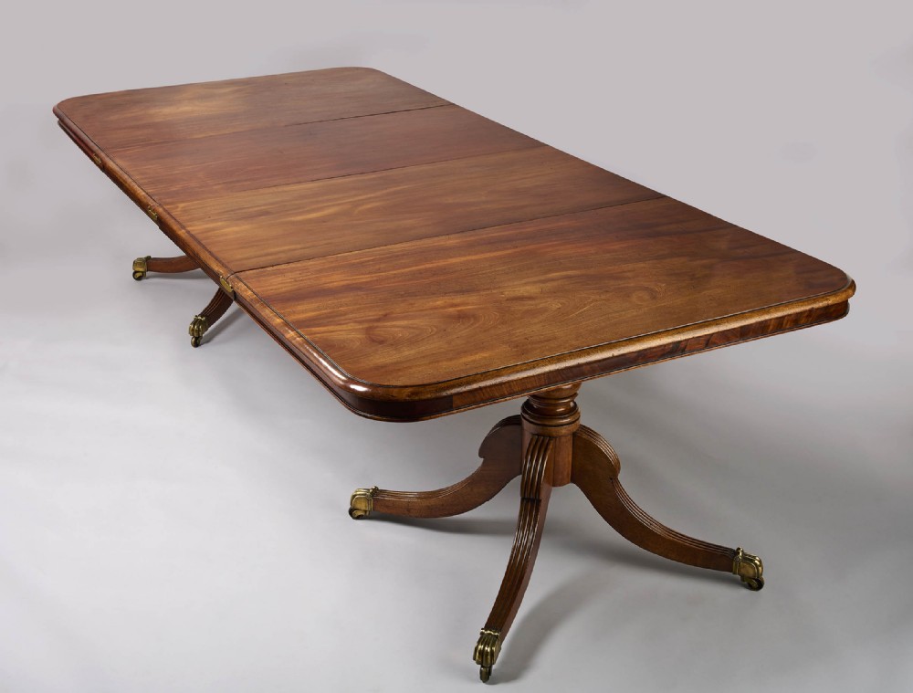 A fine George III period mahogany twin pillar dining table