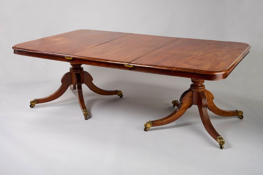 A fine George III period mahogany twin pillar dining table View III