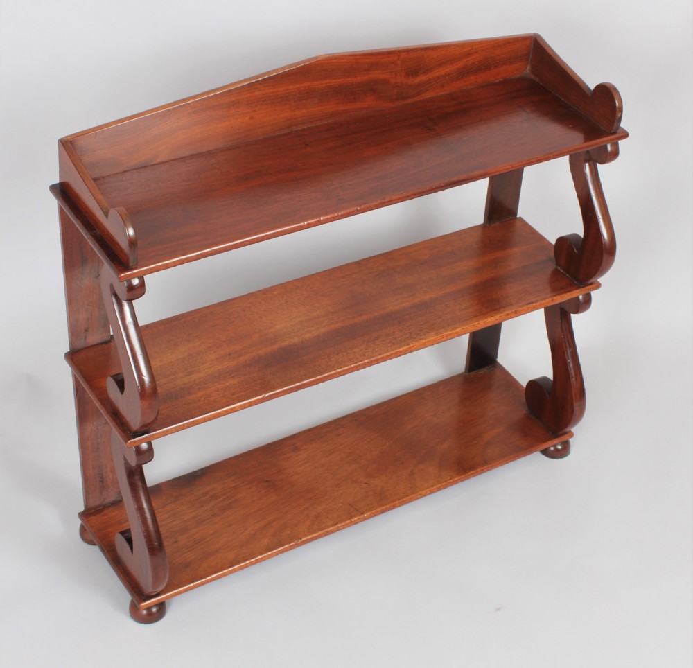 A Regency set of mahogany hanging shelves