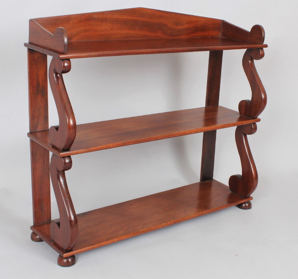 A Regency set of mahogany hanging shelves View II