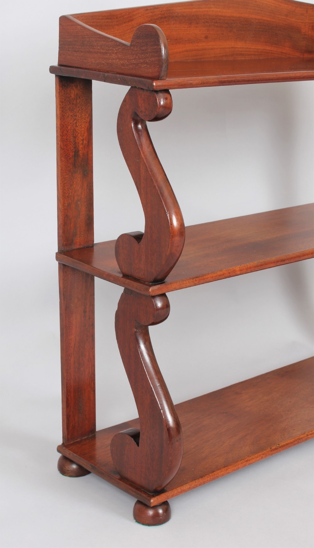 A Regency set of mahogany hanging shelves View III