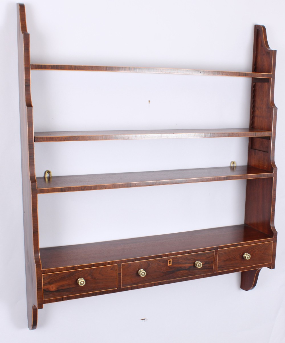 Unusual George III period mahogany hanging shelves