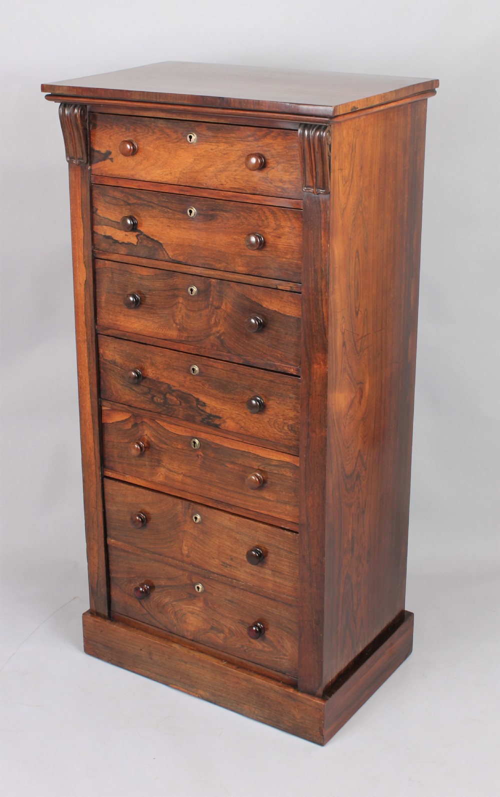 Well-figured and useful rosewood Wellington chest View V