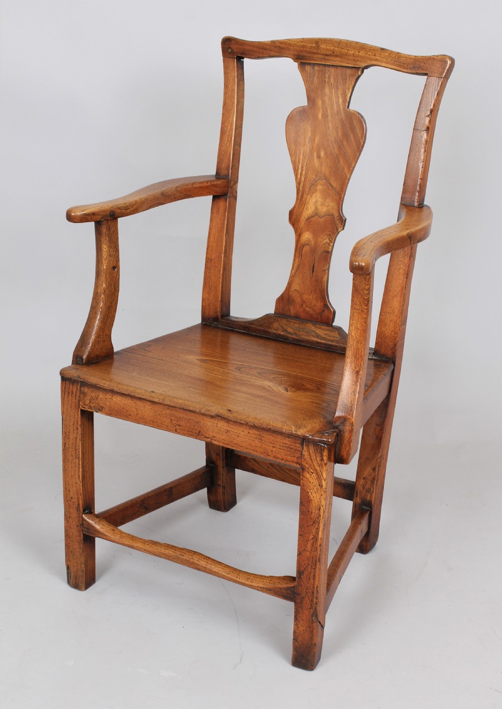 George III elm country arm chair of the Hepplewhite period