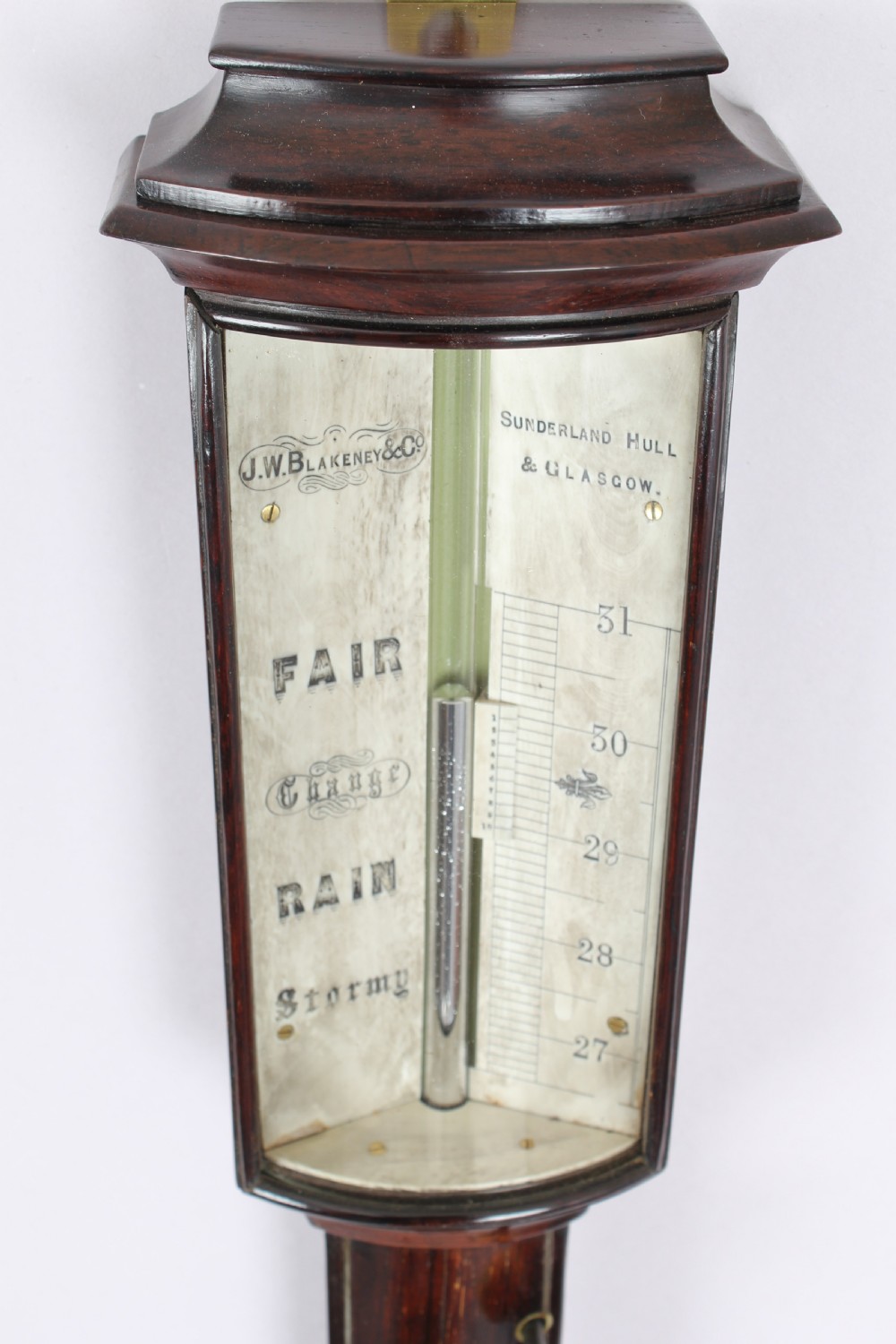 A bow-fronted marine barometer in a well-figured rosewood case View V