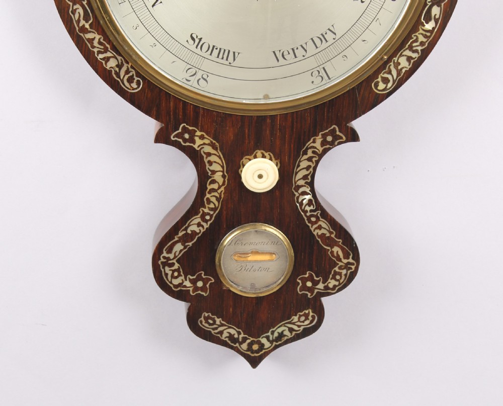 A Victorian rosewood banjo wheel barometer decorated with mother-of-pearl floral inlays, featuring a central thermometer and silvered weather dial. View II