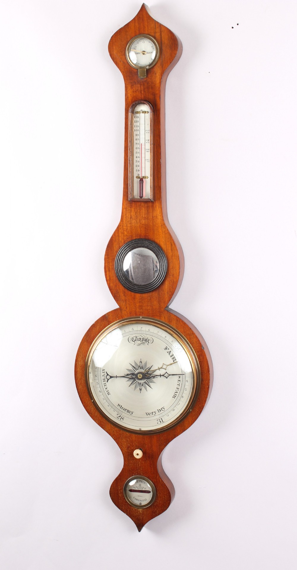 A Victorian mahogany wheel barometer featuring an onion top, upper hygrometer dial, enclosed glass thermometer, central convex mirror, silvered main dial, and lower spirit level plate by W.E. Pain of Cambridge.