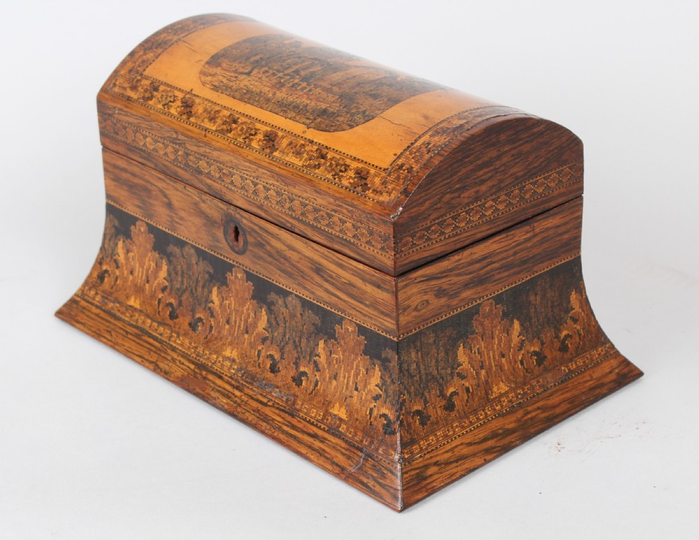A nineteenth-century domed rosewood tea caddy with elaborate geometric inlaid borders and a central landscape transfer image on the lid. View II