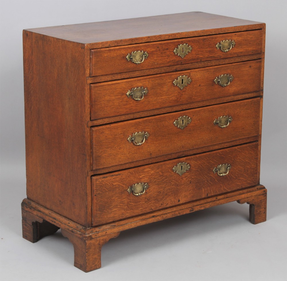 Rare George II period oak chest of drawers of diminutive size;  View III
