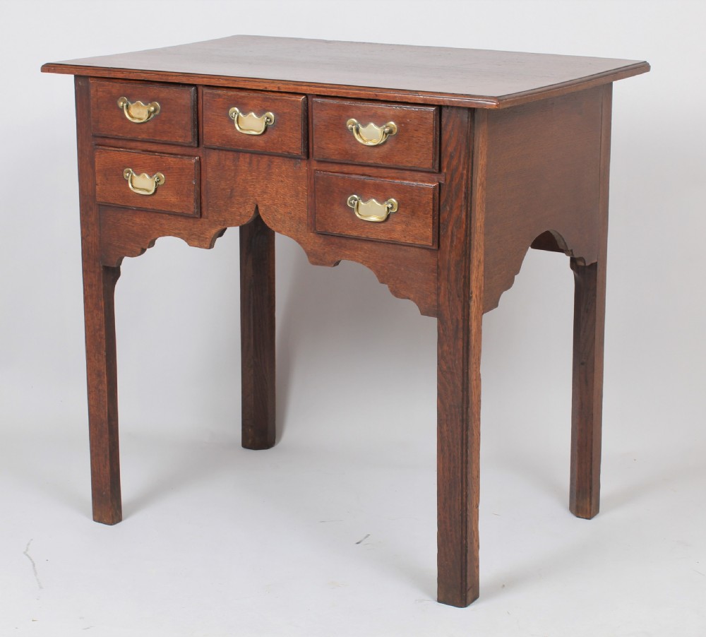 George II oak lowboy; the top with a moulded edge