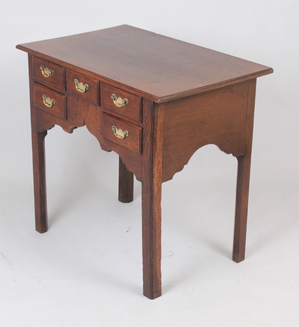 George II oak lowboy; the top with a moulded edge View II