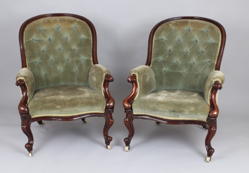 A pair of mid-Victorian comfortable easy chairs