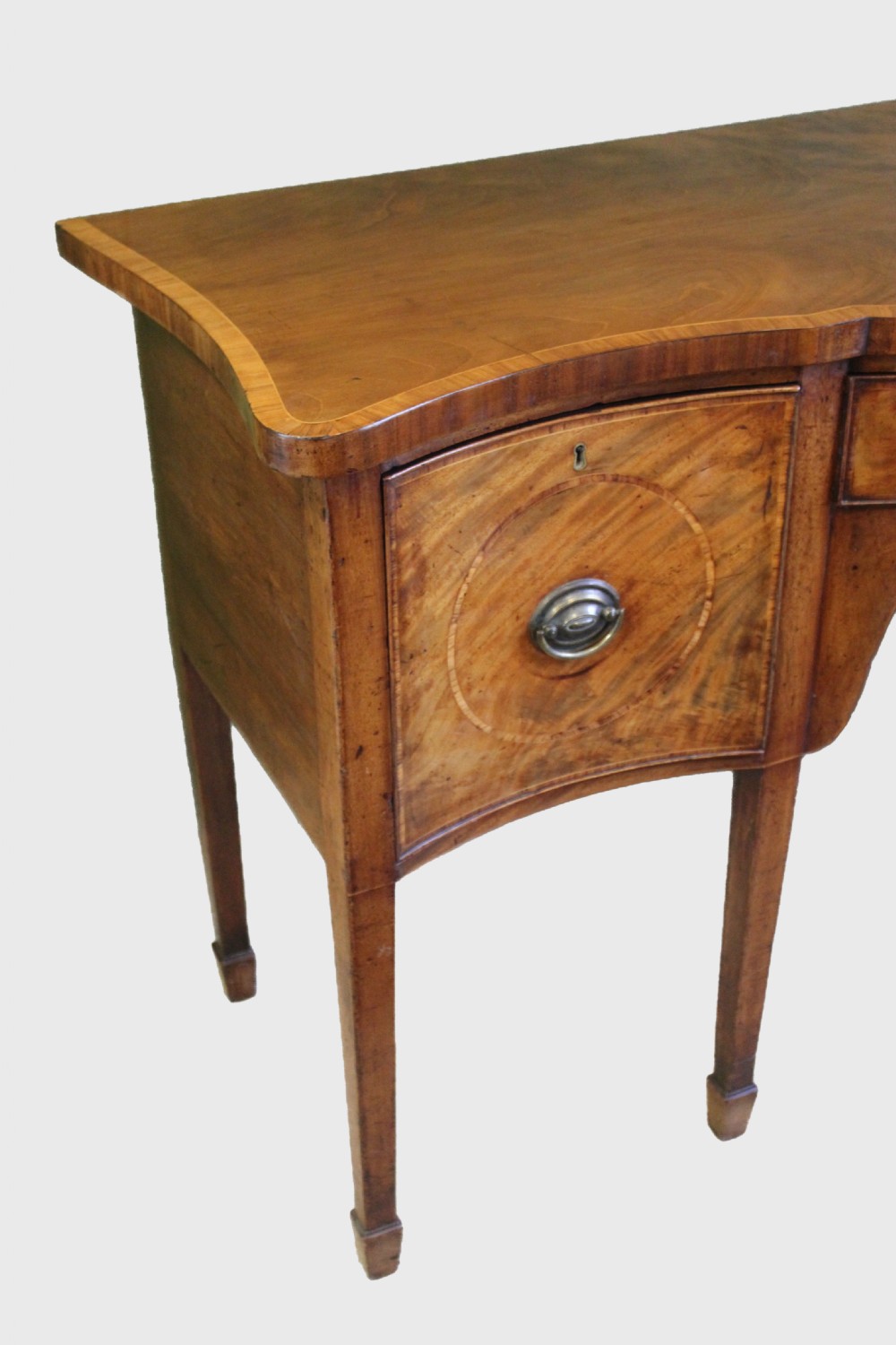 A Hepplewhite period mahogany serpentine fronted sideboard of delightfully small proportions View IV