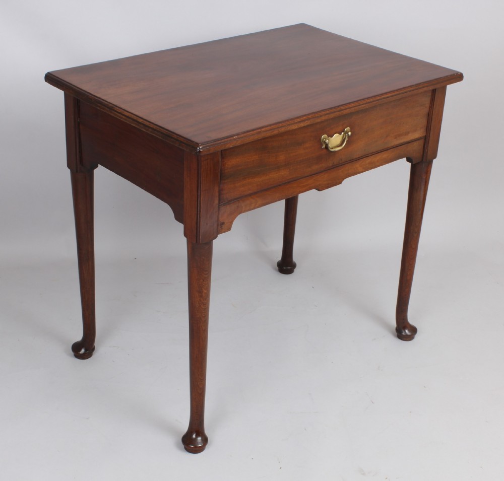 A George II Cuban mahogany side table featuring a single drawer with a central brass handle, supported by cabriole legs terminating in pad feet. View II