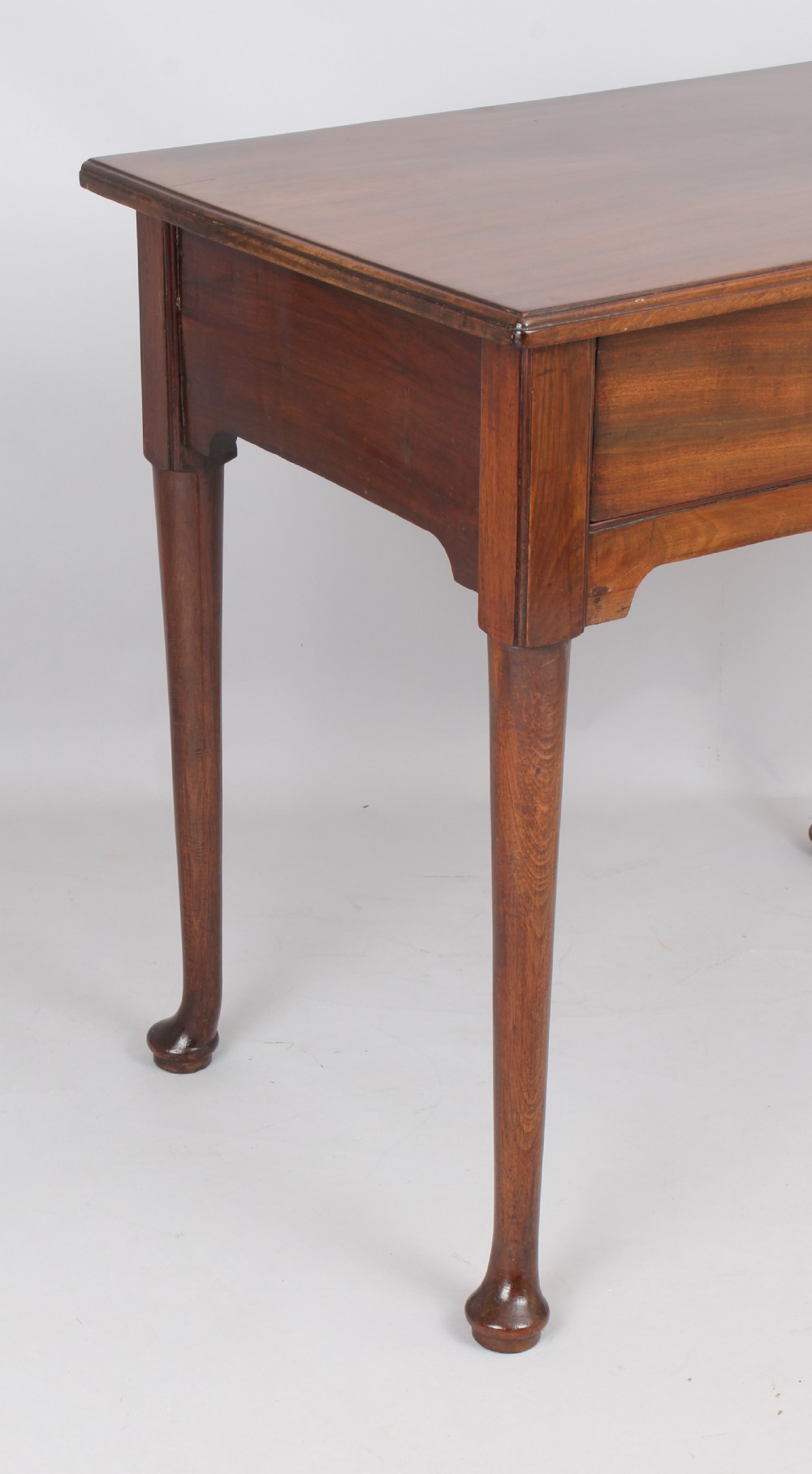 A George II Cuban mahogany side table featuring a single drawer with a central brass handle, supported by cabriole legs terminating in pad feet. View III