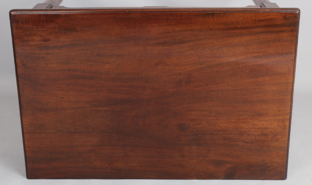 A George II Cuban mahogany side table featuring a single drawer with a central brass handle, supported by cabriole legs terminating in pad feet. View V