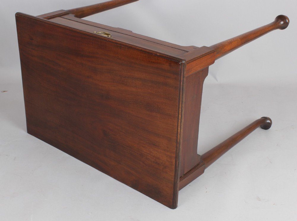 A George II Cuban mahogany side table featuring a single drawer with a central brass handle, supported by cabriole legs terminating in pad feet. View VI